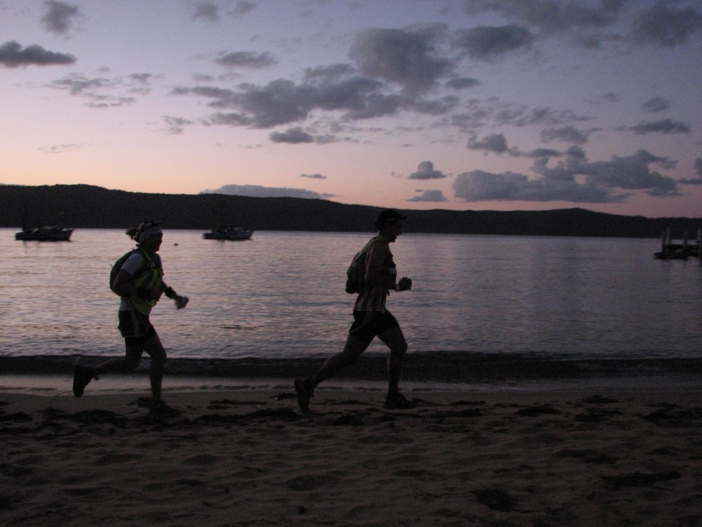 Jess running across sand as part of a team again, but this time out of the heat, before the dawn, and fast, for an aggressive and exciting 2nd place... for Nikolay at least.